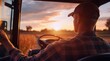 © Khmel - Farmer driving tractor at sunset in rural landscape