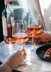 Wall Mural - Glasses of rose wine seen during a friendly party or a celebration in a restaurant of a bar.