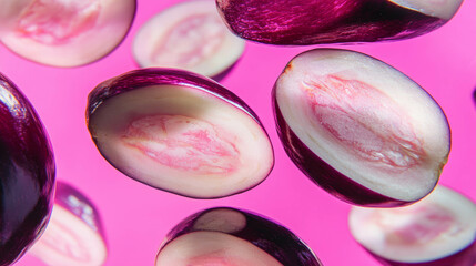 Aufkleber - Vibrant background of floating sliced eggplants on pink surface for creative design