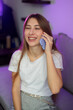 © timonko - Cheerful smiling young woman is having a pleasant phone conversation, enjoying a moment of connection and laughter in the comfort of her home