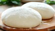 © youthe - Two pizza dough balls on wooden board, kitchen background. Food recipe website