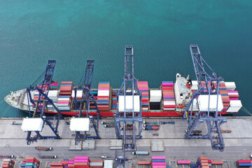 Top view of international containers cargo ship at industrial import-export port transport goods around world, global transportation and logistic business.Oversea international Business.