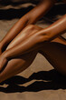 © Mirrorstudio - Sun-kissed legs on sandy beach with shadows. Skin care, sun protection