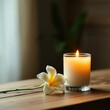 © smart - A single flower with a lit candle beside it on a wooden table, candle, elegance, warm glow