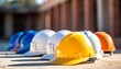 © Mikhail Vorobev - Colorful row of construction helmets on concrete floor under natural light on a sunny day