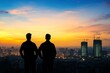© Nico - Silhouettes of Two Friends Overlooking Cityscape at Sunset with Construction Buildings