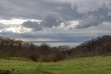 Wall Mural - cloudy sky with a bright sun peeking through the clouds