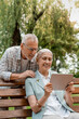 © InsideCreativeHouse - Vertical shot of happy smiling senior couple using digital tablet pad gadget device computer. Using modern technology by elderly people. Retirement warm family lifestyle concept.