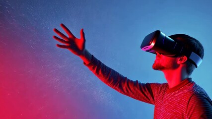 Poster - Man Wearing Virtual Reality Headset Immersed in Digital Experience with Vibrant Red and Blue Background, Surrounded by Sparkling and Glowing Atmosphere for Immersive Technology Adventure