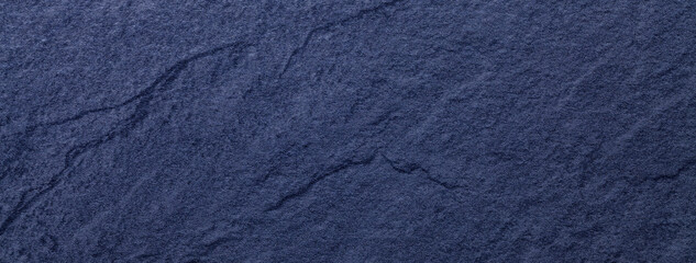 Wall Mural - navy blue background of natural slate. texture of ultramarine stone closeup. graphite material backd