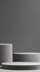 Poster - Minimalist concrete pedestals varying in size standing on gray surface, presenting sleek product display with clean geometric design and neutral color palette