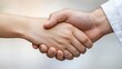 © Jakkapong - Close Up of Two Hands Shaking, Showing Detailed Skin Texture Against a Soft Neutral Background