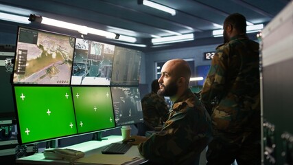 Poster - Military agent working in control room, using isolated screen software on laptop, analyzing aerial reconnaissance data. Intelligence corps expert controlling drones with mockup notebook, camera B