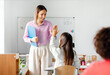 © Home-stock - Happy European female teacher giving high five to schoolgirl after lesson in private school. End of educational year, teaching concept