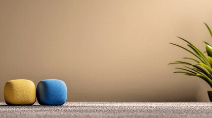Poster - Textured Yellow and Blue Cubes on Gray Surface with Beige Background