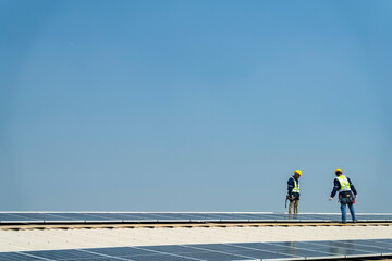Wall Mural - team of professionals installs solar panels, ensuring energy efficiency and sustainable development.