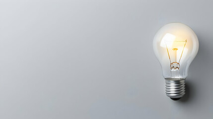 Poster - Bright Light Bulb Illuminating Simple Gray Background Design