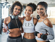 © peopleimages.com - Happy women, portrait and fitness with friends at gym for workout, exercise or training together. Faces, female people or active group with smile or dumbbell for teamwork or wellness at health club