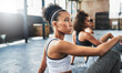 © Donson2000/peopleimages.com - Women, fitness and break with class for workout, exercise or training together at indoor gym. Female people, active group or friends listening for pilates instructions, health tips or yoga session