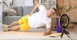 © Pixel-Shot - Male trainer recording sports video on phone at home