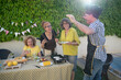 © Antonio - Joyful backyard barbecue gathering with friends sharing laughter, delicious grilled food, and fresh ingredients under the sun in a warm and festive summer atmosphere