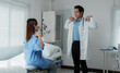 © Phimwilai - Doctor guiding patient through physical therapy exercises in hospital room
