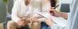 © Pormezz - Spouses relationship consultant concept, Close-up hands of psychologist holding pen and note during therapy talk session for married couple that mental health breakdown and relationship problems.