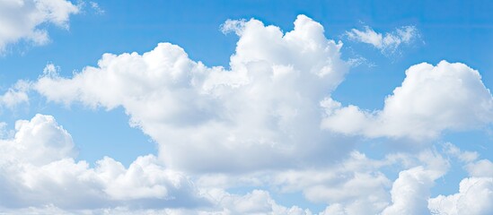 Poster - Serene spring sky with pale blue backdrop and fluffy white clouds scattered across; perfect for copy space and serene atmospheres.