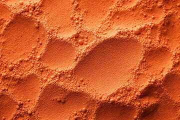 Poster - Close-up of orange textured surface with light shadows and fine powder particles.