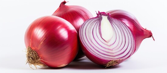 Poster - Fresh red onions with shiny skins stacked together, one cut in half revealing purple and white layers, set against a clean white background.