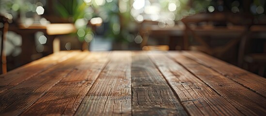Poster - Wooden table in the foreground with rich brown textures and a softly blurred green background creating a calming atmosphere for displays