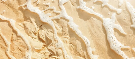 Aufkleber - Beige sandy beach texture with wet sand and gentle waves creating a natural flow, providing ample copy space for design use.