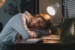 © Phimwilai - Exhausted asian office worker sleeping at desk after working late at night