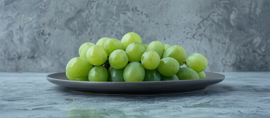 Poster - Green grape cake sculpture arranged on a dark plate, with round green grapes positioned artistically against a textured gray background.