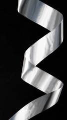 Poster - Mesmerizing silver ribbon twisting against black dramatic background in artistic motion