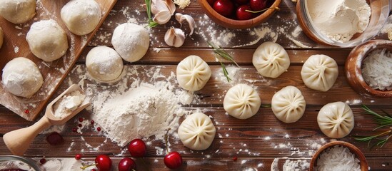 Poster - Closeup of uncooked cherry dumplings varenyky with flour, cherries, garlic on wooden table, overhead view highlighting raw ingredients and textures