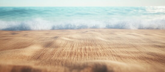 Aufkleber - Serene beach scene with gentle waves lapping onto soft golden sand under a bright blue sky with hints of white clouds in the background.