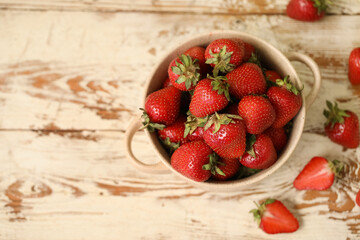 Wall Mural - Bowl with sweet fresh strawberries on white wooden background