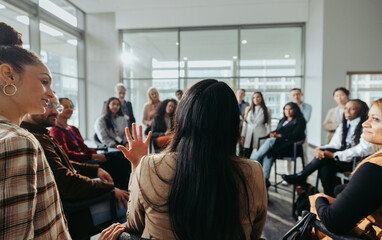 Wall Mural - collaborative team meeting: coworkers engaged in discussion in a modern office