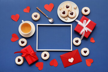 Canvas Print - Composition with empty picture frame, sweet cookies, cup of tea and gifts for Valentine's Day on blue background