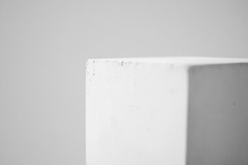 Poster - Close-up view of a white concrete block showcasing texture and minimalistic design elements in a neutral background