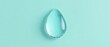 © Nathamanee - A clear drop of water sits on a blue background