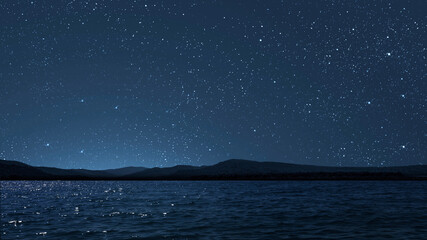 Wall Mural - a movement of stars in the night sky with the view of mountains..
