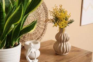 Canvas Print - Vase with mimosa flowers and decor on shelf near beige wall, closeup