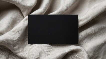 Poster - Black business card on textured linen background for modern branding and identity display. Perfect for minimalistic design concepts.