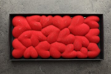 Sticker - Chocolate bar decorated with hearts in box on grey table, top view