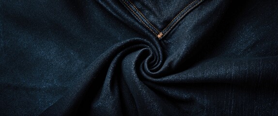 Poster - Textured black denim fabric with detailed stitching showcasing its rich color and softness, perfect for fashion and textile backgrounds.