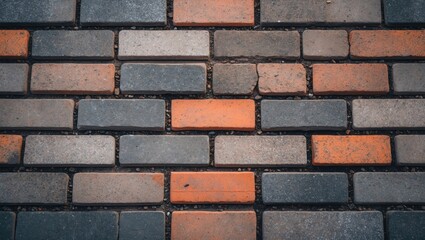 Poster - Texture of paving slabs with varied brick floor pattern in shades of grey and orange, suitable for backgrounds or architectural designs.