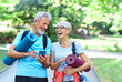 woman man senior couple active fitness elderly phone mobile smartphone happy together communication active outdoor healthy vitality exercise mat class training