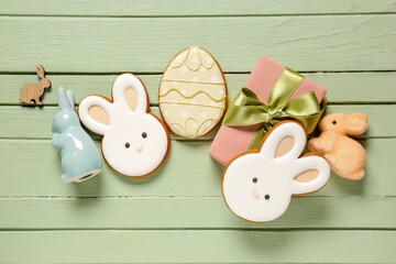 Wall Mural - Gift box, decor, Easter cookies in shape of egg and bunny on green wooden background